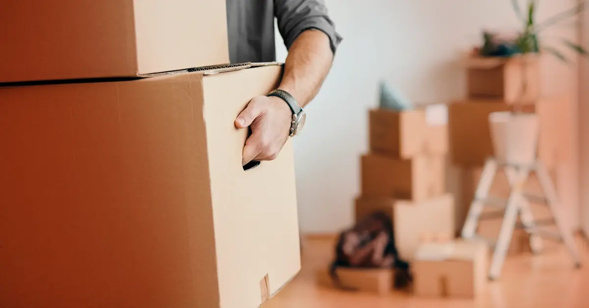 Man moving boxes into a new apartment