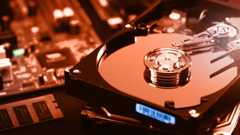 Close-up of an open hard drive, red lighting