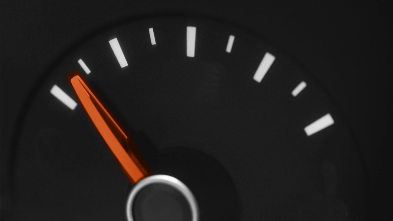 Black speedometer dial with a red needle