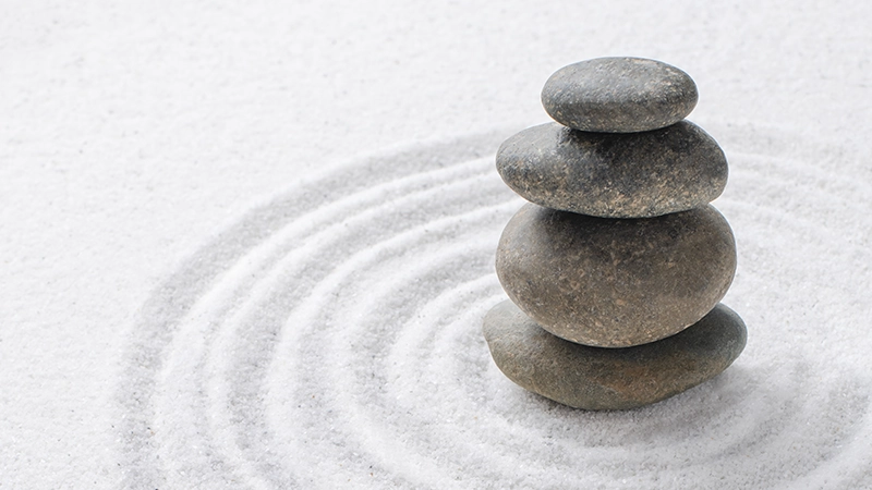 Stacked stones on zen sand