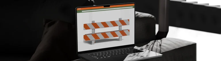 Laptop displaying an orange and white construction barrier
