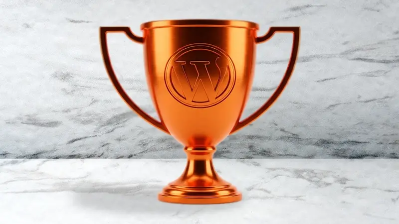 Gold trophy with WordPress logo on marble