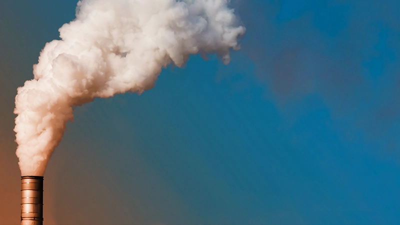 Thick smoke billowing from a factory.